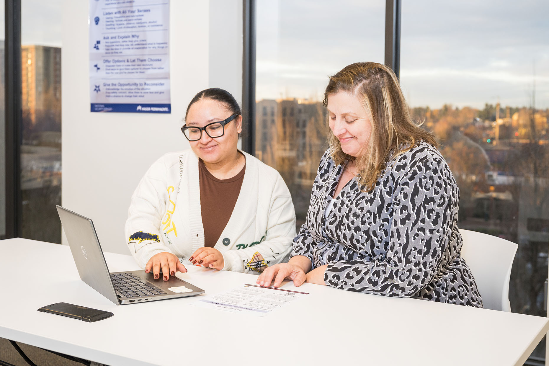 two women viewing laptop together