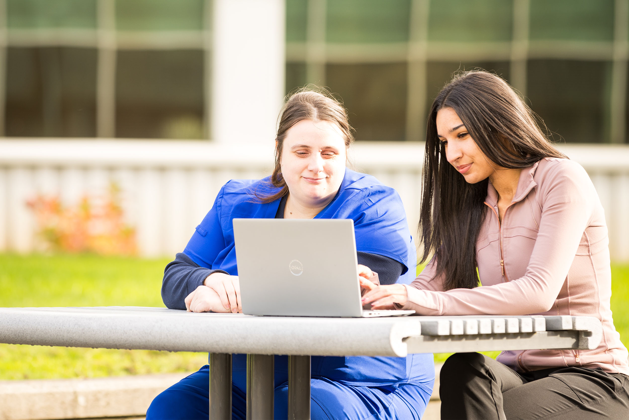 two professional women looking at laptop