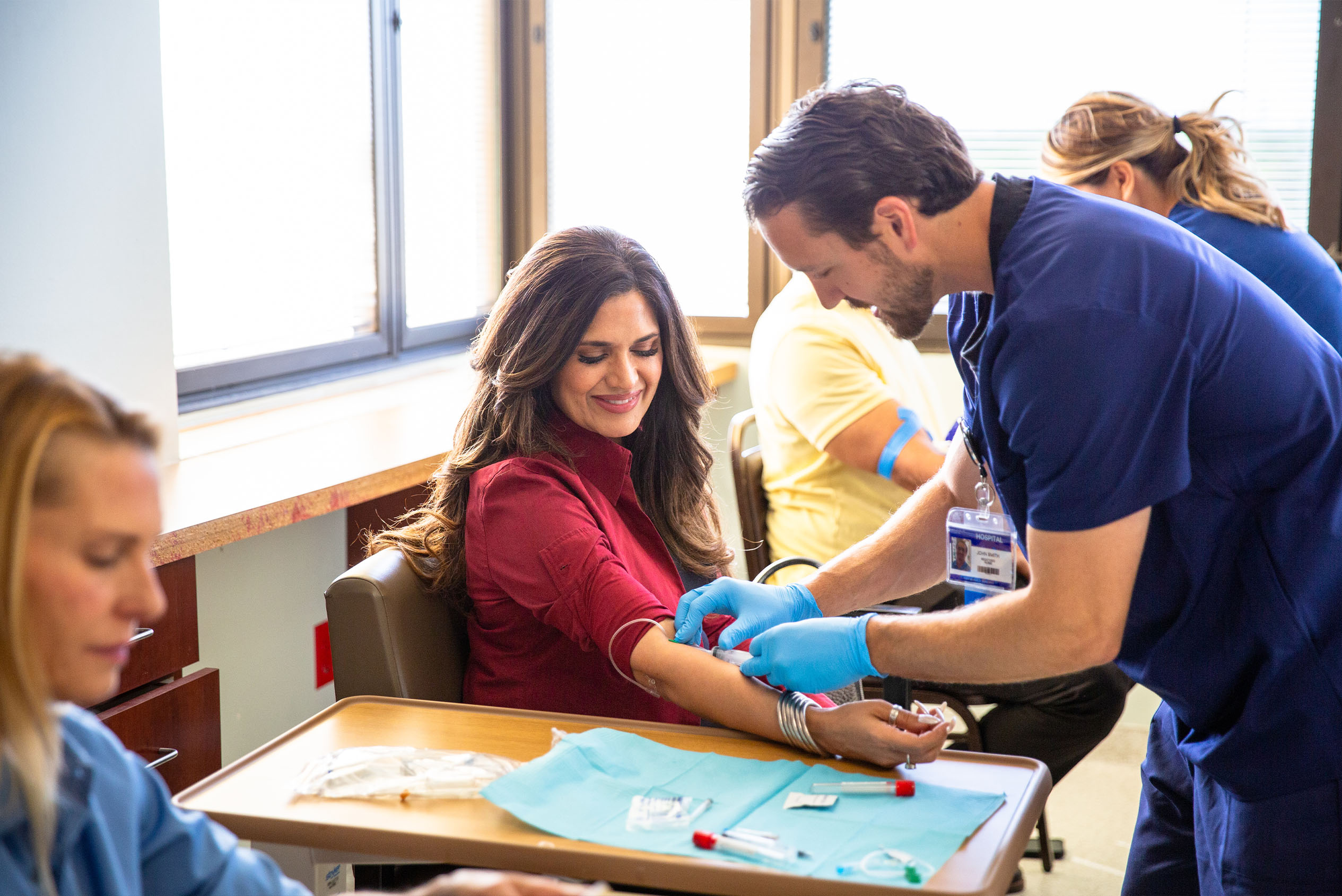medical worker helps drawing blood from patient
