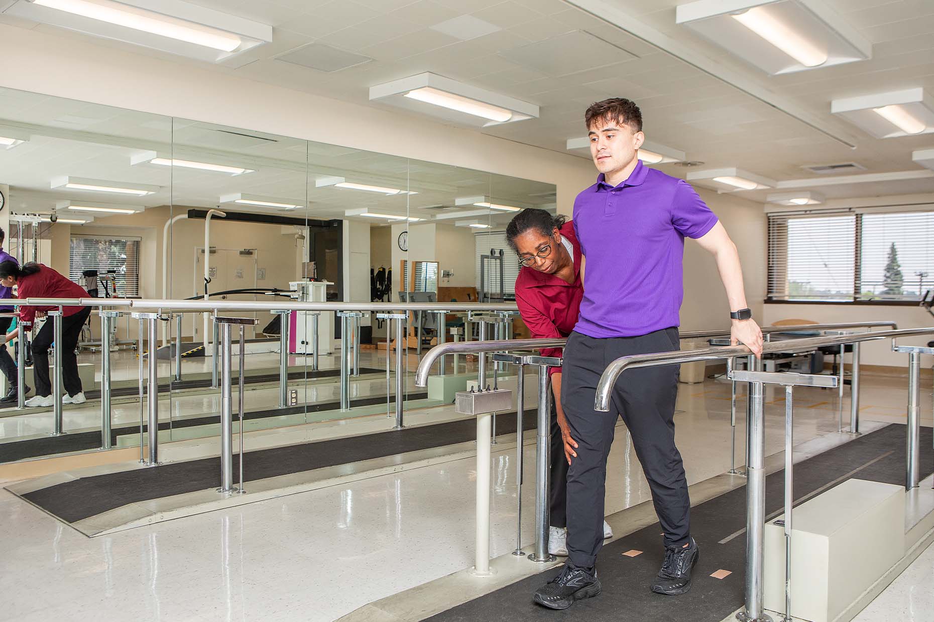 physical therapist helping patient exercise