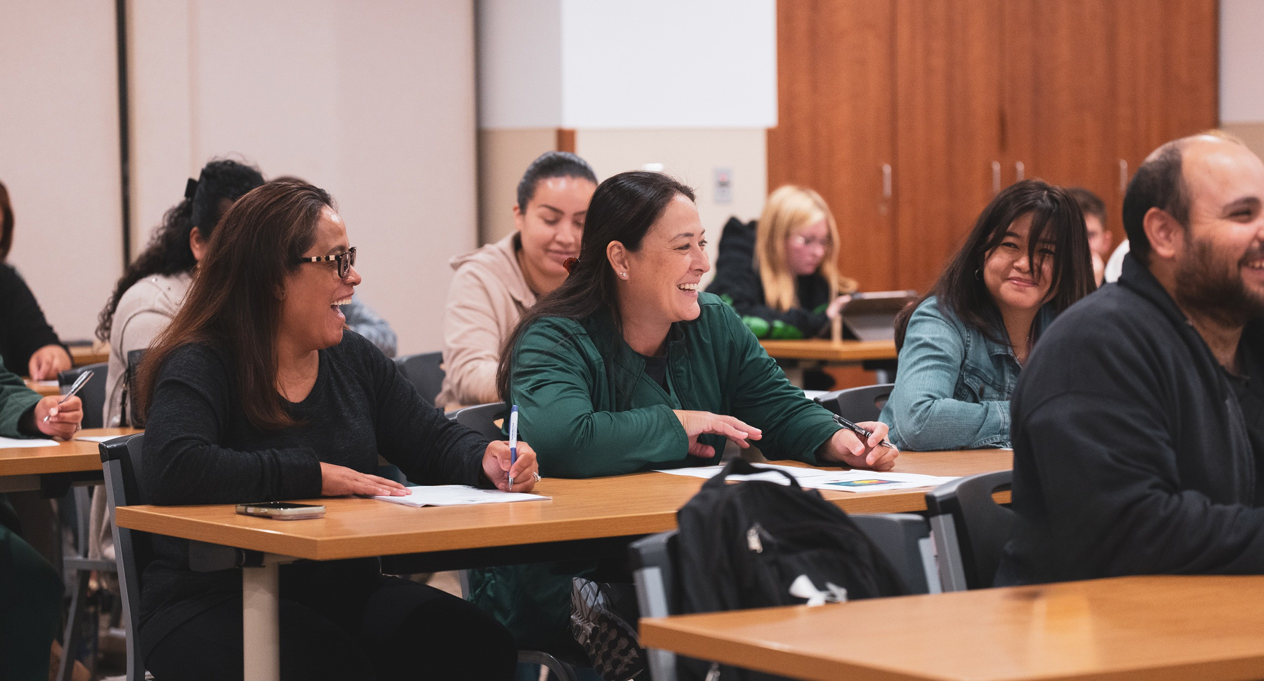 People smiling during an in person college class.